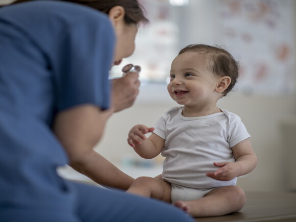 A doctor checks a baby for allergies and intolerances.