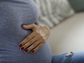 A woman having backpain, one of the signs of labor