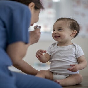 It is important to check in with your pediatrician after discovering allergies and intolerances A doctor checks a baby for allergies and intolerances.