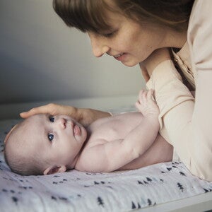 Bathing your baby can be a vital part of your son’s daily routine. A Mother caressing after bathing her baby.
