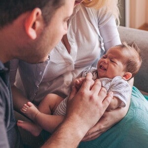 Learn everything you need to know about colics in babies A newborn crying to illustrate colics in babies.