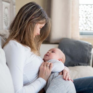 Maternity leave is crucial to the health of the mother and the baby. A mother taking care of his baby during maternity leave.