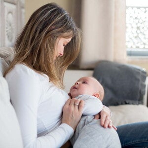 Fever in toddlers can be concerning to a lot of parents A woman with her baby taking care of a fever in toddlers.