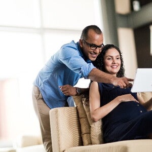 Prepare for the emotional challenges of parenthood with this guide. A pregnant couple preparing for parenthood.