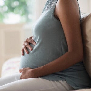 Understand the causes and intricacies of pregnancy pains. A pregnant woman coping with pregnancy pains.
