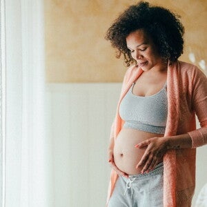 Learn about the first pregnancy symptoms and red flags A pregnant woman after the early pregnancy symptoms