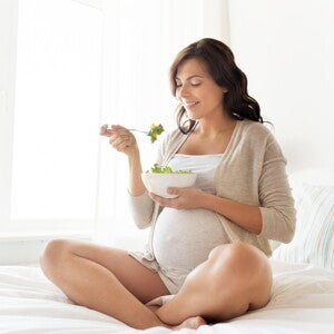 Part of your diet is taking note of what not to eat pregnant A woman enjoying food while avoiding what not to eat when pregnant.