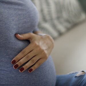 A woman having backpain, one of the signs of labor