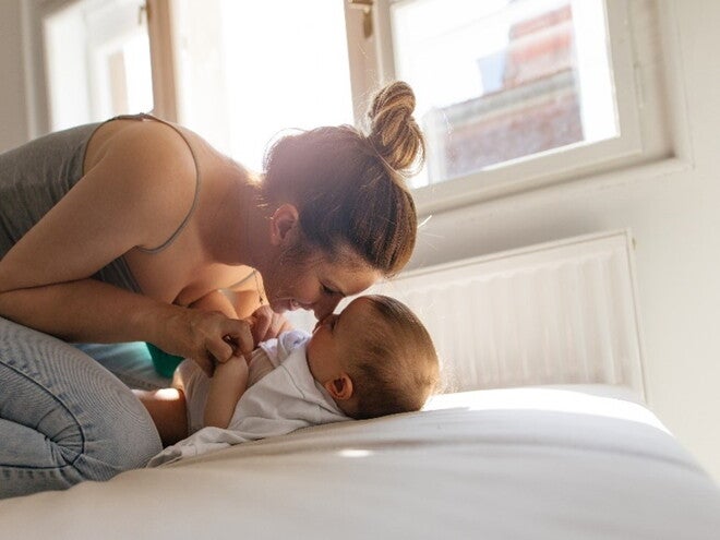 A mother encouraging her baby's first words through playtime