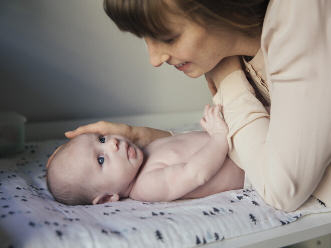 A Mother caressing after bathing her baby. 