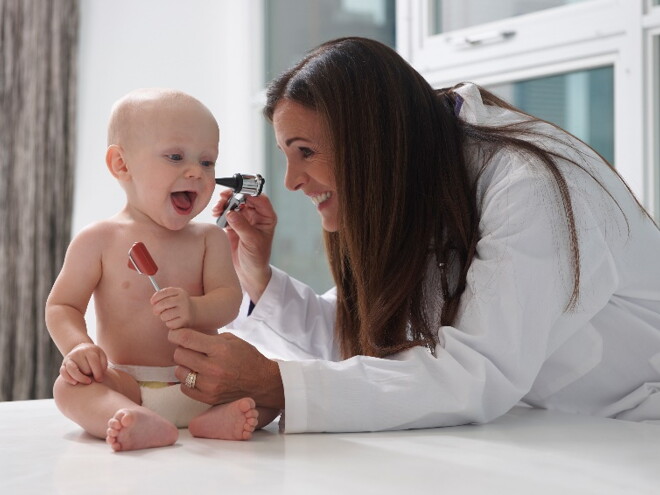 An ear infection is quite common in babies and infants A baby is being checked for an ear infection by a pediatrician.