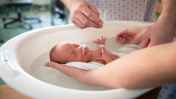 Parents give a bathing their baby in the hospital