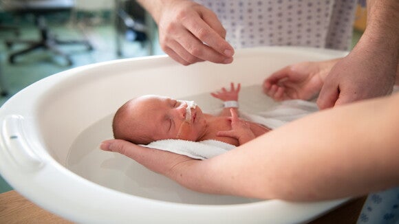 It’s vital to ask a pediatrician when you can bath your baby Parents give a bathing their baby in the hospital
