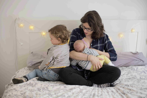 A woman feeding her child after having a good breastfeeding diet.