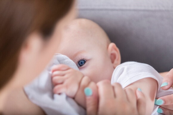 Breastfeeding problems may include some important health issues A baby looking at their mother while breastfeeding