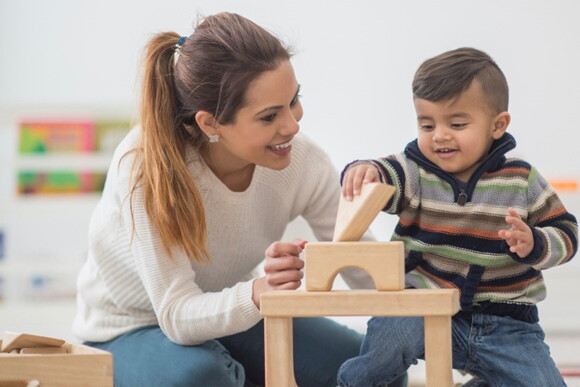 A mother playing with her child and enjoying motherhood.