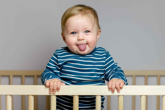A baby using his tongue during the prelinguistic stage of language development. 
